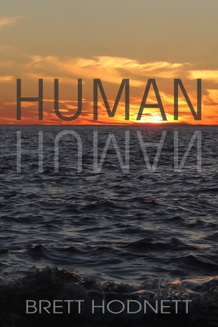 The book cover of HUMAN. The cover is a photograph of a setting sun over open water. The bottom two thirds of the image is dark choppy waters, the top third is an orange sky with sparse clouds lit by a deep orange sun already mostly below the horizon. Overlaid over this image is the title, HUMAN, in large dark text written just above the dark waters. In lighter text, the title is reflected in the water below. At the bottom of the page in smaller grey text is the authors name, Brett Hodnett.